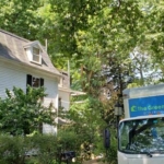 A photo of the home being renovated and The Green Cocoon truck.