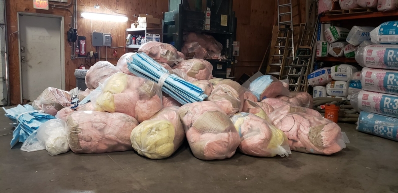 a pile of fiberglass insulation from a clients home