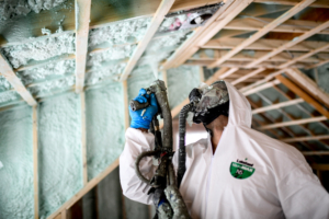 spray foam insulation contractor spraying ceiling - green-cooon